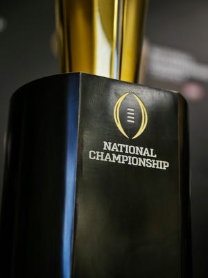 The college football playoff championship trophy is unveiled on July 14, 2014, during a news conference at the college football playoff headquarters.