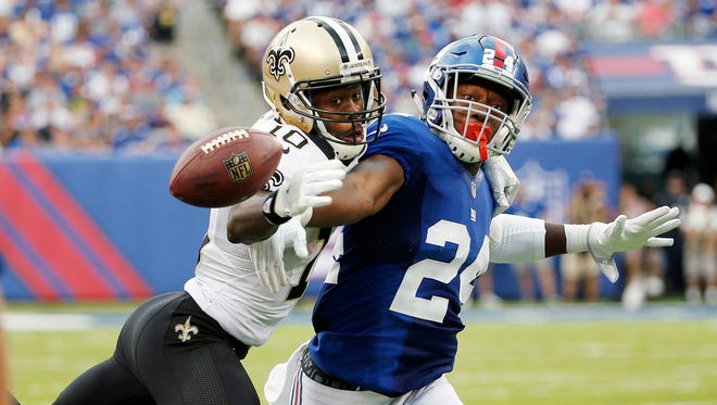 New Orleans Saints wide receiver Brandin Cooks (10) and New York Giants' Eli Apple (24) fight for the ball during the second half  Sunday.