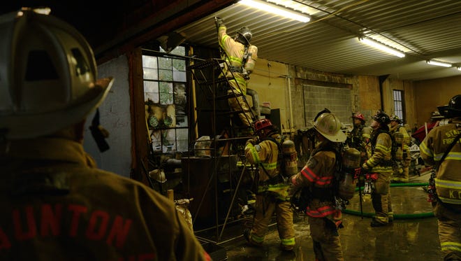 Staunton firefighters respond to a fire inside Larry's Small Engine Service on Van Fossen Lane in Staunton on Monday, Nov. 30, 2015.