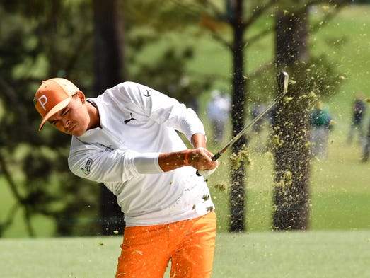 Rickie Fowler hits from the fairway on the 1st hole