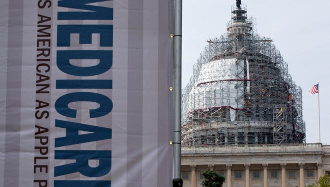 A 2015 file photo shows a sign supporting Medicare  on Capitol Hill in Washington.