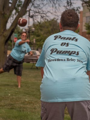 Participants  warm up for the Pants vs. Pumps games at McCamly Park on Sunday as part of Pride Weekend 2016.