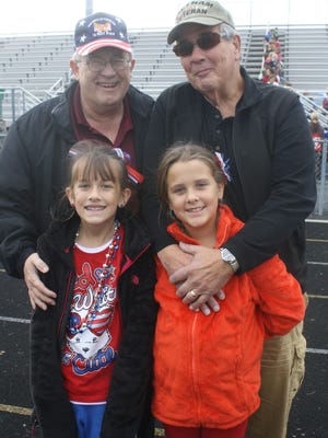 
Vietnam veterans Jerry Woten and Bob Holtkamp with their granddaughters Cammie and Cara Woten.
