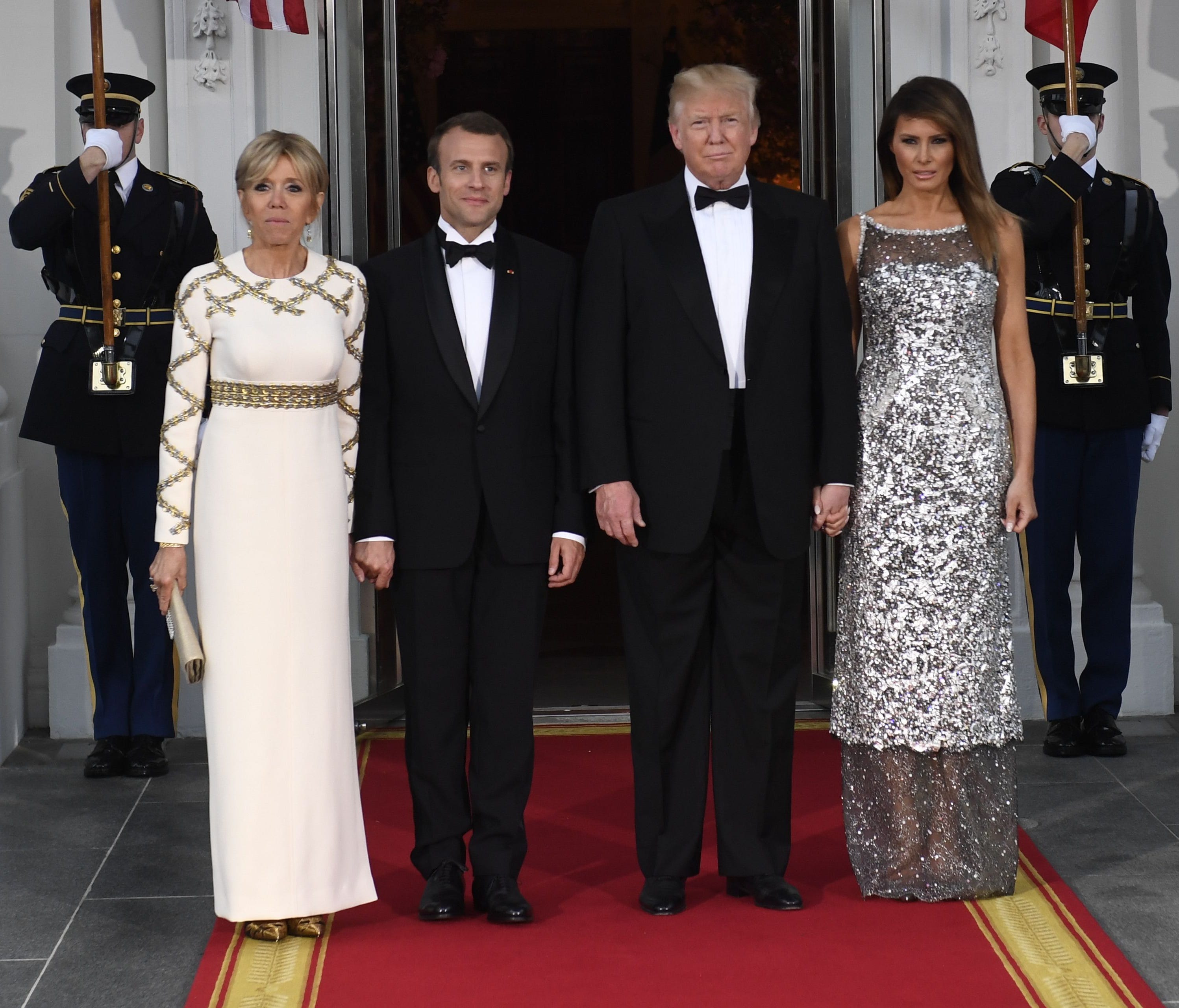 President Trump and first lady Melania Trump welcome French President Emmanuel Macron and his wife, Brigitte Macron, as they arrive for a State Dinner at the North Portico of the White House in Washington.