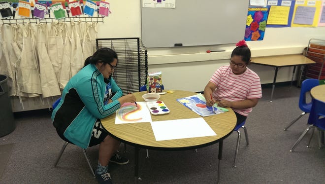 Two youngsters served by Big Brothers Big Sisters of San Juan County take part in a painting activity. The organization recently merged with Big Brothers Big Sisters of Central New Mexico.