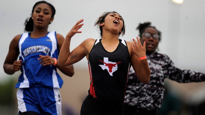Eastland's Jessie Jacobs (center) celebrates after winning the girls 100m during the Region I-3A track meet on Saturday, April 29, 2017, at Elmer Gray Stadium in Abilene. Jacobs won the race with a time of 12.27.