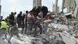 Rescuers work survivors amid the rubble of a collapsed