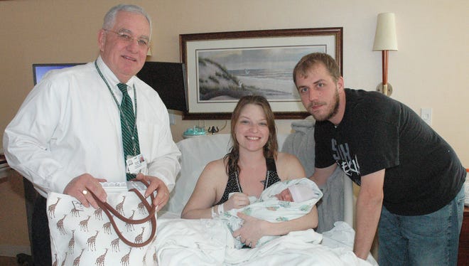 Michael K. Winthrop, president of The Bellevue Hospital, congratulates Lillian Belle Seamon, the first baby born at the hospital in 2018, and her parents Lindsey Ransom and Dustin Seamon, of Clyde.