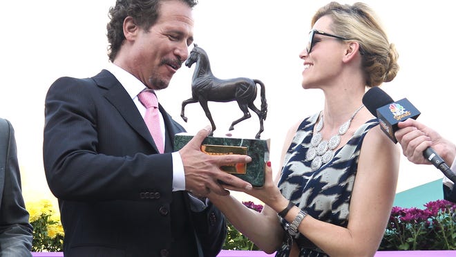 
Jim Rome, left, and actress Elizabeth Banks are seen on Day 2 of the Breeders' Cup World Championships on Saturday Nov. 3, 2012, in Arcadia, Calif.
