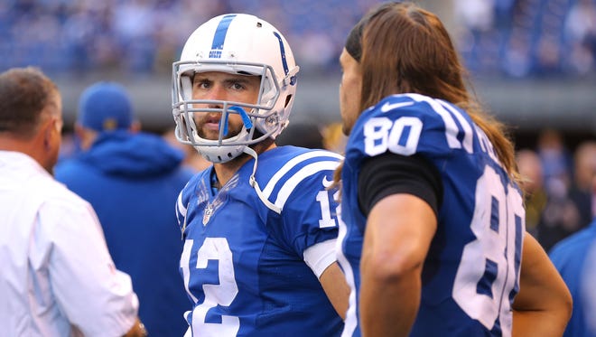 Indianapolis Colts quarterback Andrew Luck (12), standing with tight end Coby Fleener (80) as the game clock is about to expire during the second half of an NFL football game Sunday, Oct. 25, 2015, at Lucas Oil Stadium. The Saints won 27-21.