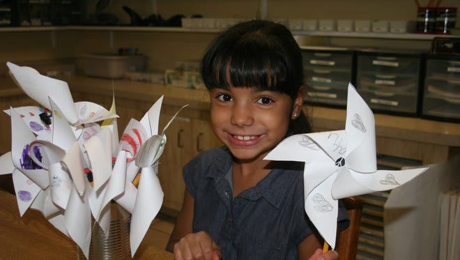 Miriya DiJoy, a first-year student in the Lower Elementary classroom of Sun Grove Montessori School, displays her pinwheel of peace.