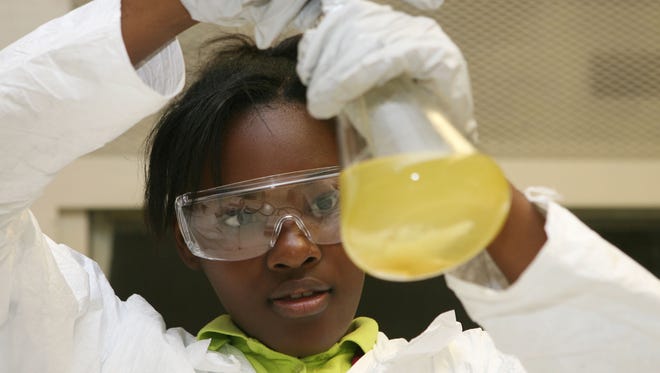 Silvia Long analyses the color of the biodiesel that she and other students from Monroe City Schools produced on Wednesday in a week-long summer camp at The University of Louisiana at Monroe.