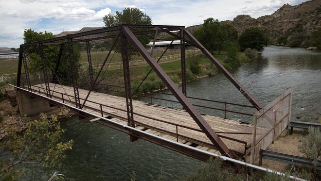 Some Cedar Hill residents are asking San Juan County officials to rehabilitate and reopen this closed steel truss bridge over the Animas River for pedestrian traffic.