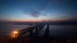 The sun rises over the bridge on the banks of the Yalu