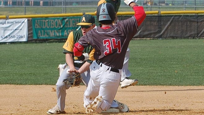 Haddonfield's Ryan Shedev is safe at second with a stolen base as Audubon's Ryan Coyle has the ball slip off his glove.
