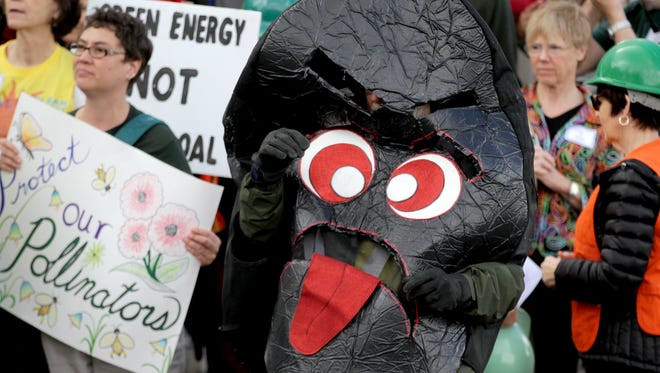 Mac McKinlay, of Portland, dresses as a piece of coal during a Coal to Clean Energy rally at the Oregon State Capitol in Salem on Tuesday, March 24, 2015.