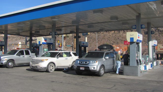 Visitors gas up at a station in St. George.