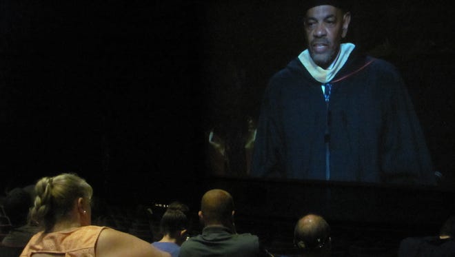 Former NBA All-Star and pro basketball coach Lionel Hollins appears on a screen in front of a Cox Auditorium overflow crowd attending Dixie State University's commencement exercises Friday, May 4, 2017. The university presented 1,785 degrees to 1,699 students. Nearly half -- 42.8 percent -- of the degrees were baccalaureates, a sign the university is continuing to develop more four-year degree options.