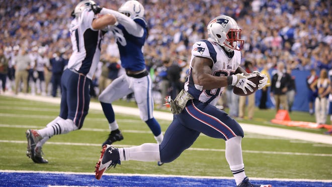 New England Patriots running back Jonas Gray scrambles in for his fourth touchdown against the Colts. Indianapolis hosted New England at Lucas Oil Stadium on Sunday, November 16, 2014. 