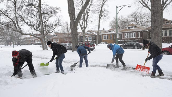 Volunteers shovel sidewalks on South Wabash Avenue in the Chatham neighborhood Saturday, Jan. 19, 2019, in Chicago. Organized by My Block, My Hood, My City, more than 50 people gathered to clear snow from sidewalks and front steps throughout the South Side.