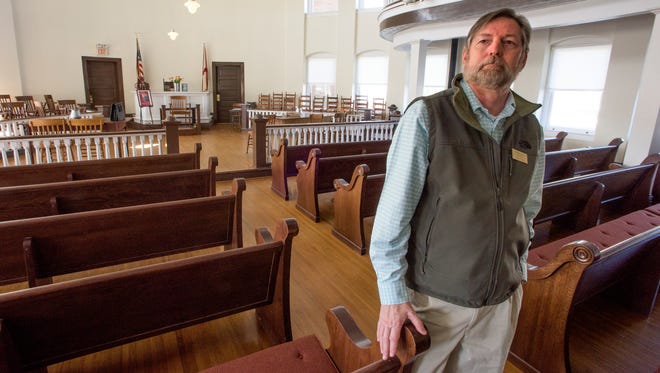 Nathan Carter stands in the courtroom at the Old Monroe County Courthouse in Monroeville, Ala. as he reminisces about Harper Lee, who died Feb. 19, 2016.