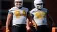 Tommy Sprague (64) and Brian Garvey (69) look on during