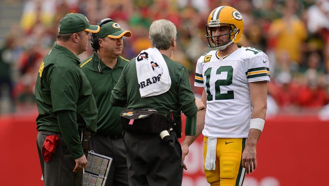 Green Bay Packers quarterback Aaron Rodgers stretches his calf during the second quarter of Sunday's game at Raymond James Stadium in Tampa, Fla.