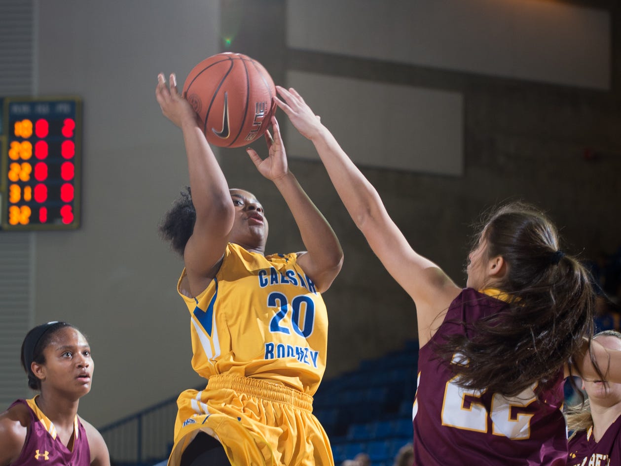 St. Elizabeth’s Juliann McCarron (22) reaches to stop a shot by Caesar Rodney’s Brionna Brooks (20) in the quarterfinals of DIAA Girls Basketball Tournament at the University of Delaware.