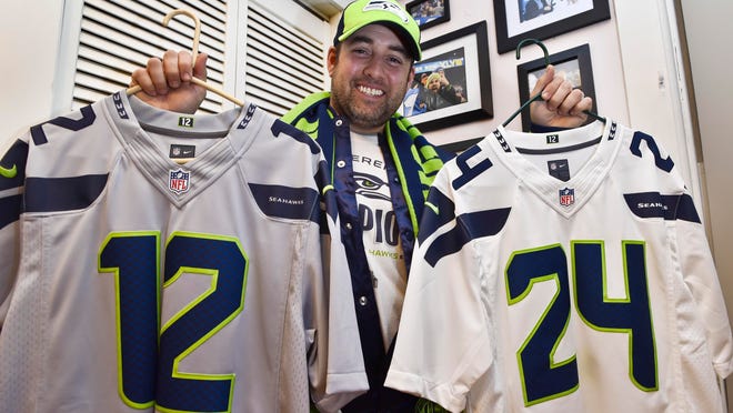 Seahawks fan Eli Erwin with a small portion of his memorabilia at home in East Middlebury on Friday.