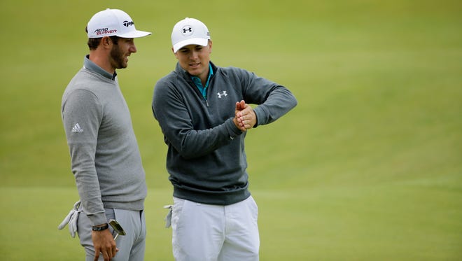 United States’ Jordan Spieth, right, and United States’ Dustin Johnson chat after finishing on the 18th green during the first round of the British Open Golf Championship at the Old Course, St. Andrews, Scotland, Thursday, July 16, 2015.