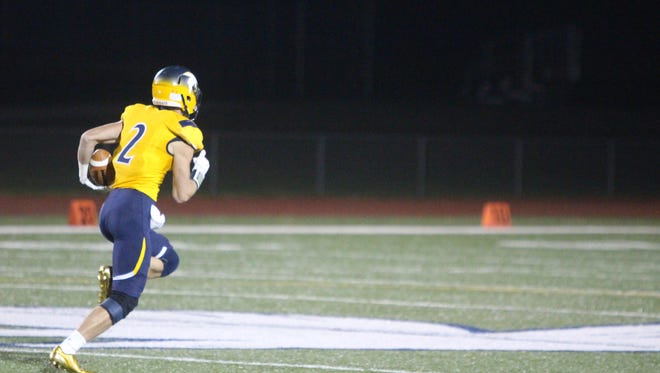Daniel Alexopoulos breaks into the open field on a 77-yard touchdown catch and run for Whitnall in Level 1 of the playoffs Oct. 20.