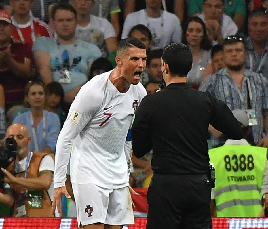 Portugal's Cristiano Ronaldo argues with Mexican referee Cesar Ramos during the match against Uruguay.