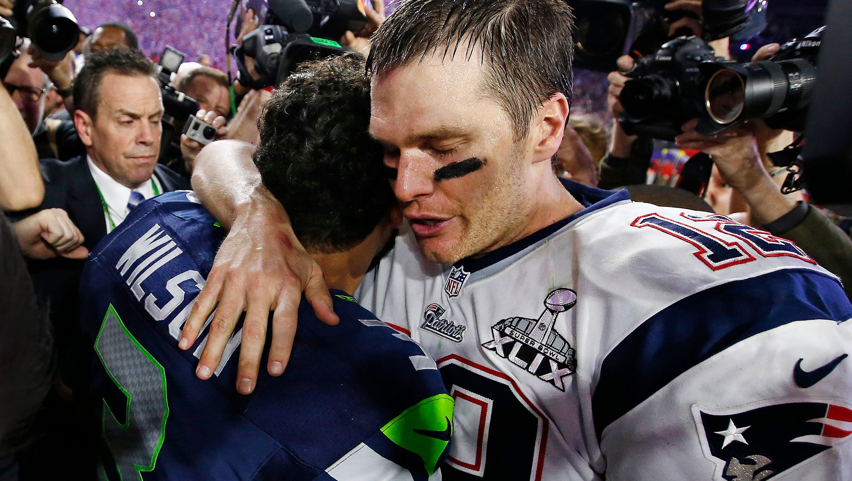 Tom Brady hugs Russell Wilson at Super Bowl XLIX