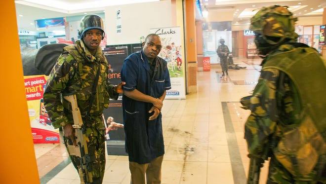 A severely wounded man is rescued by Kenyan troops during a battle against Somali militants at the Westgate Mall on Sept. 21 in Nairobi.