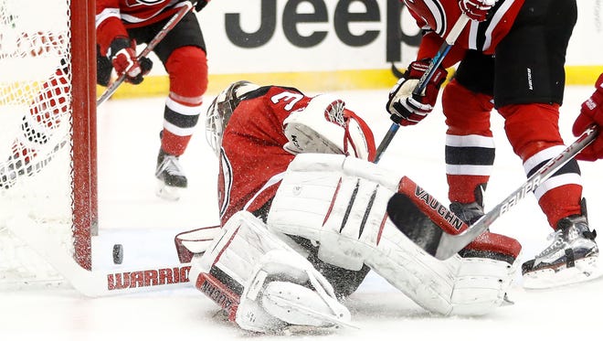 Cory Schneider and the Devils fall in overtime to the Detroit Red Wings on Friday, Nov. 25, 2016, in Newark, N.J. Devils' Beau Bennett (8) and Kyle Palmieri (21) look on.