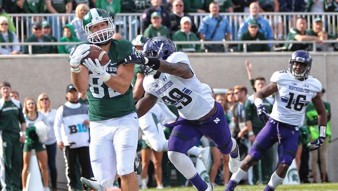 Oct 15, 2016; East Lansing, MI, USA; Michigan State Spartans tight end Josiah Price makes a TD catch against the Northwestern Wildcats during the first quarter at Spartan Stadium.