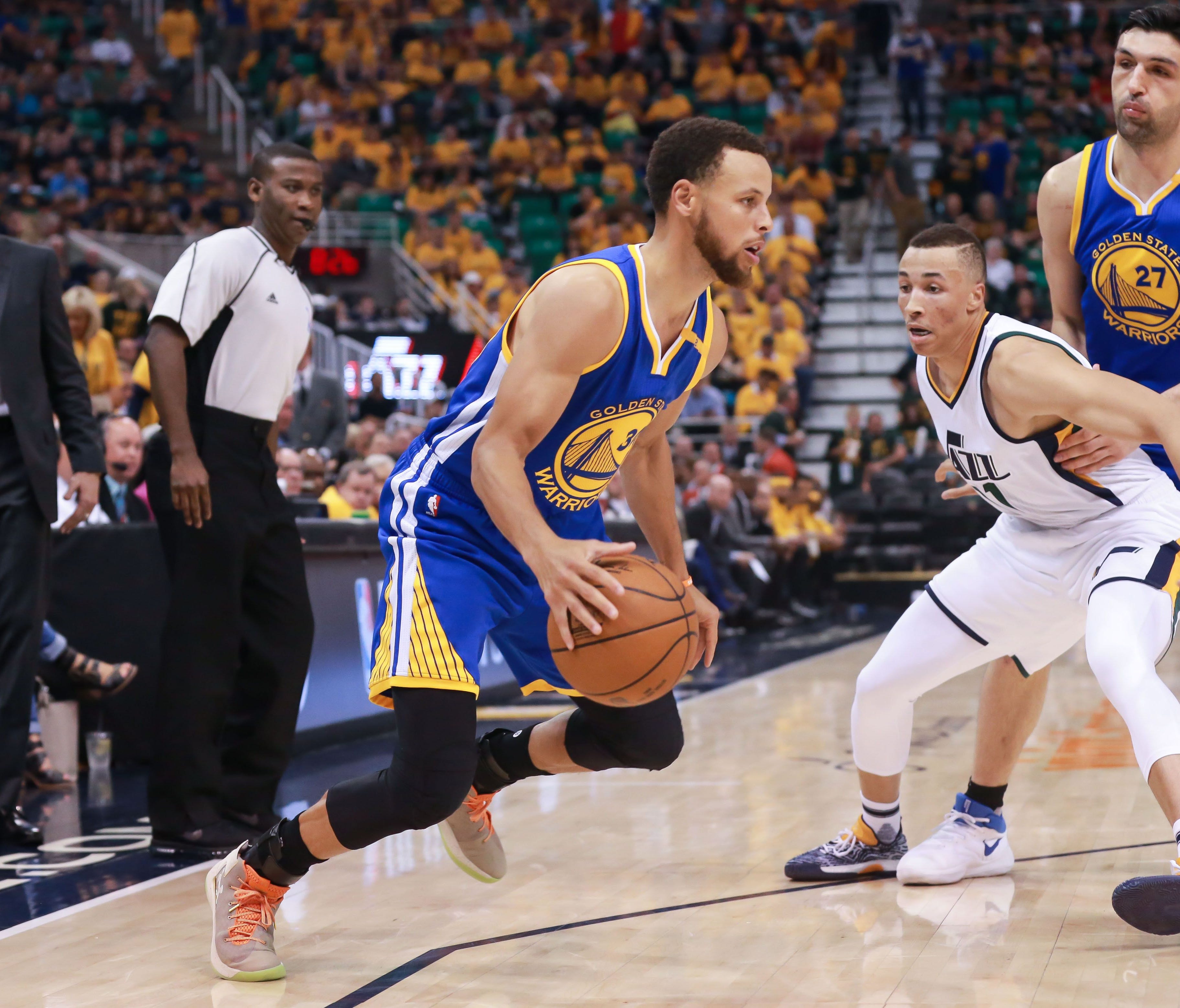 Golden State Warriors guard Stephen Curry controls the ball against Utah Jazz guard Dante Exum during the third quarter in Game 4.