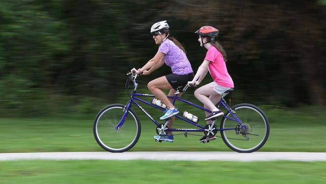 The Route 66 Tandem Cyclists provided a biking experience to area blind Saturday, June 4. Valery Box, left, and  Mia Perry, 12, enjoy their ride.