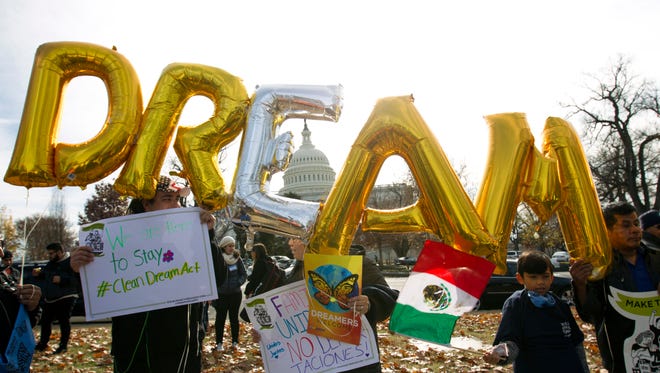 FILE - In this Dec. 6, 2017, file photo, demonstrators hold up balloons during an immigration rally in support of the Deferred Action for Childhood Arrivals (DACA), and Temporary Protected Status (TPS), programs, near the U.S. Capitol in Washington. Casting a cloud over already tenuous negotiations, President Donald Trump said Sunday, Jan. 14, 2018, that DACA, a program that protects immigrants who were brought to the U.S. as children and live here illegally, is “probably dead” and blamed Democrats, days before some government functions would start shutting down unless a deal is reached. (AP Photo/Jose Luis Magana, File)