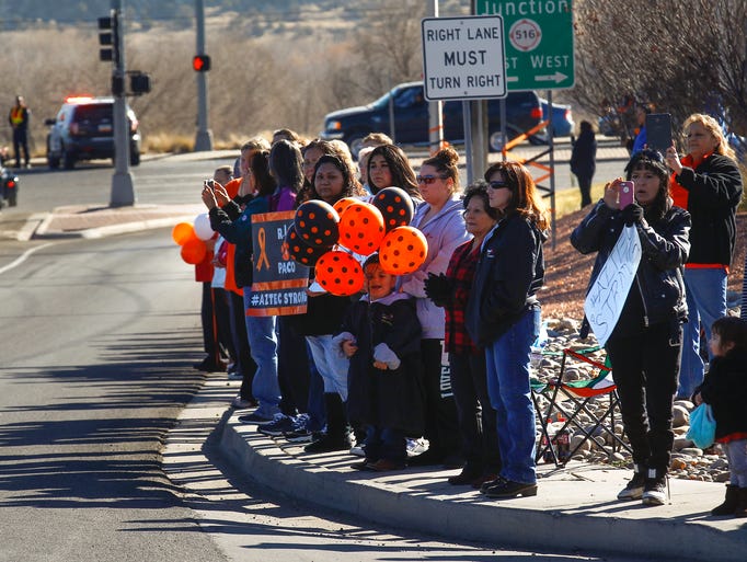 Mourners watch as a funeral procession for Francisco
