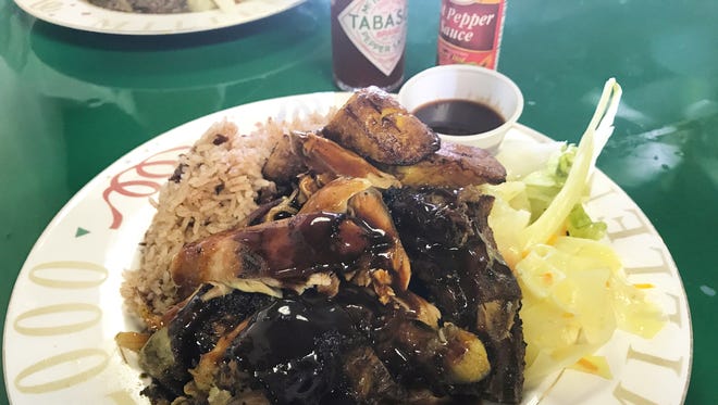 Jerk chicken with steamed cabbage and pigeon peas with rice from Irie I in Fort Myers.