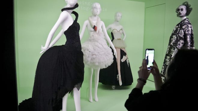 Fashion from, from left, Gucci, Givenchy, Moshino and Marc Jacobs appear at a press preview Monday in the Metropolitan Museum of Art’s Costume Institute exhibit, titled, “Camp: Notes on Fashion.”