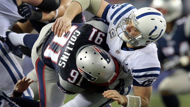 Andrew Luck, shown here getting hit by the New England's Jamie Collins, has struggled in his first two games against the Patriots.