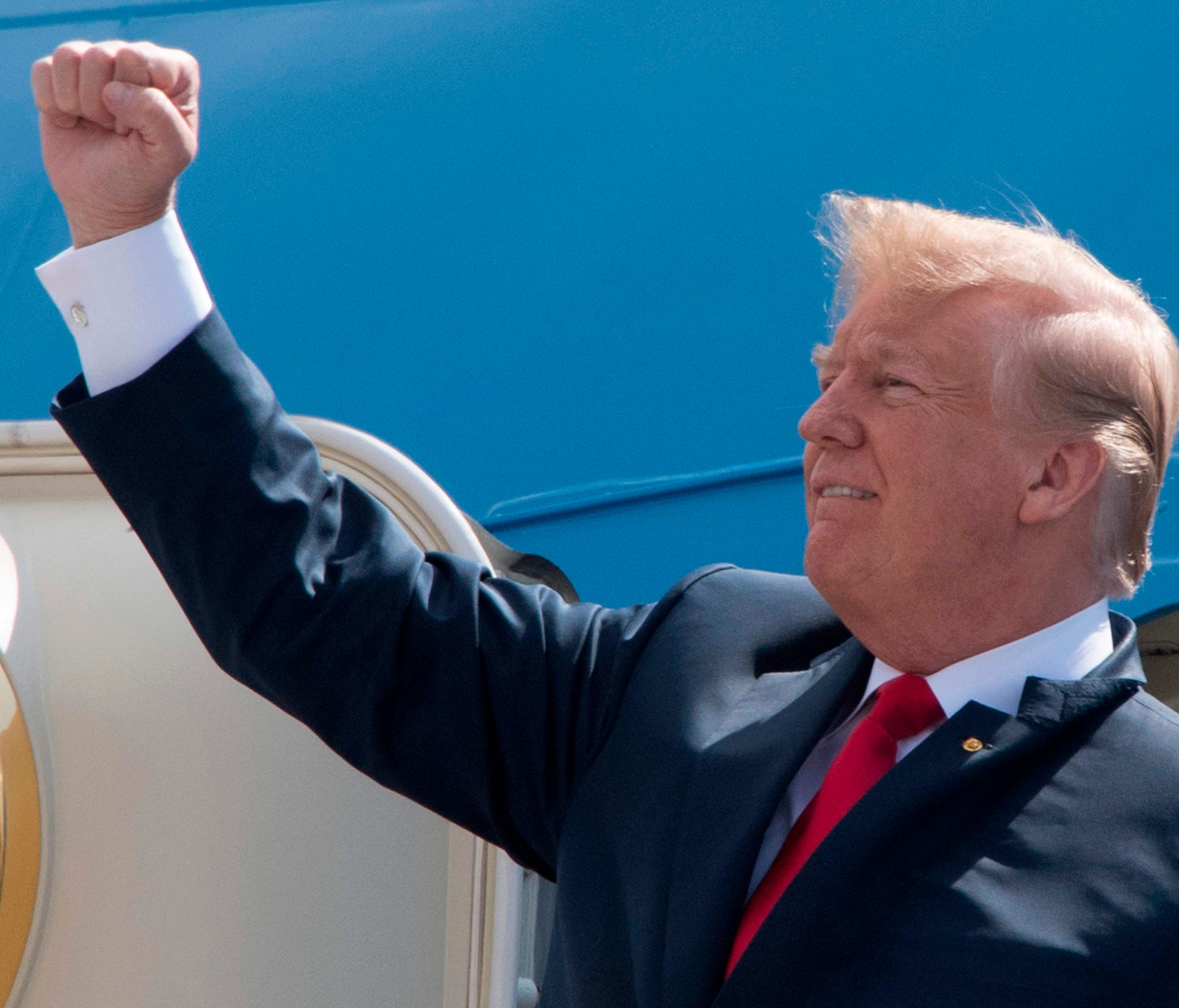 President Trump pumps his fist to the crowd as he arrives at Ellington Field Joint Reserve Base in Houston, Texas on May 31, 2018.