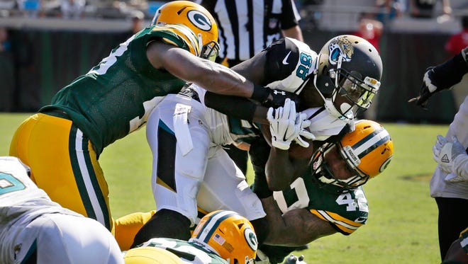 Jaguars wide receiver Allen Hurns (88) is pulled down by a swarm of Packers defenders on fourth down in the final seconds of the game Sunday in Jacksonville.
