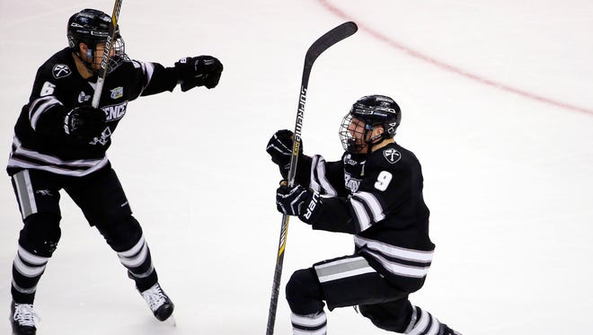 Fairport's Trevor Mingoia, right, shown celebrating his goal in the Frozen Four last year for Providence, is one of the top returning scorers for the defending NCAA champions.