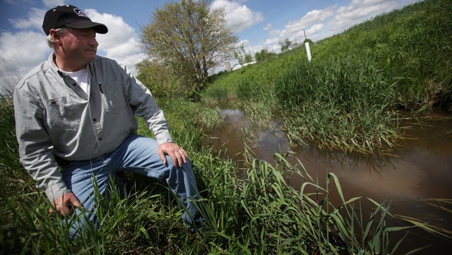 Doug Darling, 54, stands by the Amos Palmer drain on his farm in Monroe County where he grows wheat, corn and soybeans. Proposed revisions to the federal Clean Water Act by the EPA and Army Corps of Engineers have Michigan farmers like Darling concerned about additional paperwork, cost and time.New water rules proposed by the EPA have Michigan farmers concerned. They could designate even minor wetlands or drainage ditches on farms as "Waters of the United States," requiring a federal permit, delay and cost to modify.