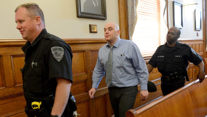 Kenneth Stahli is led out of the courtroom by Sheriff deputies Monday during the lunch recess.