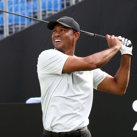 Tiger Woods hits his tee shot on the 8th hole duri