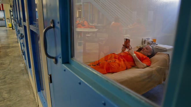 Army veteran David Weekes reads in his cell inside the veteran's pod at the Albany County Correctional Facility, Monday, Nov. 27, 2017, in Albany, N.Y. Albany County's jail devotes one of its housing units for veterans, an increasingly common feature of state and county lockups as the criminal justice system focuses more on helping them reintegrate into society. (AP Photo/Julie Jacobson)